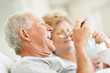 Senior man eating a fruit salad with a senior woman