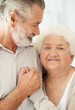 A loving mature man looking at a happy senior female