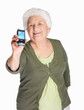 Happy mature woman displaying her mobile isolated on white