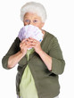 An elderly woman holding currency notes on white background