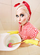 Attractive girl cleaning toilet
