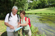 Senior couple looking at map on hiking day