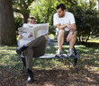 person reading paper over shoulder