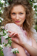 lovely blonde in blooming garden