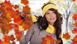 Beautiful woman wearing hat and gloves and maple leaves Beautiful woman wearing hat and gloves and maple leaves