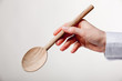 Hand holding wooden spoon