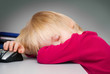 The boy has fallen asleep near the computer The boy has fallen asleep near the computer