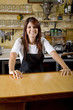 Waitress behind counter working in restaurant