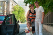 Happy parents near a new car and child here
