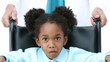 portrait of an african little girl sitting in a wheelchair