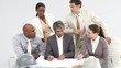 Multi- ethnic architects studying plans