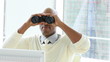 serious businessman looking through spyglasses