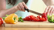 Close-up of a woman cutting vegetables in her kitchen at home