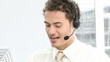 hispanic man working in a call center with headset on