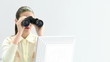 attractive businesswoman looking through binoculars