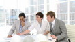 businessmen and businesswoman watching plans in office