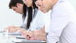 four people taking notes sitting at a table