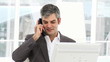 Smiling businessman calling by phone