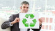 Positive businessman showing the concept of recycling