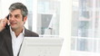happy business man on phone working with computer