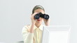 Elegant businesswoman looking through binoculars