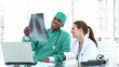 smiling doctors examinating x-ray