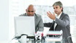 confused businessmen in front of a computer