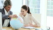 manager with young executive looking at a terrestrial globe