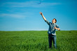 young man throwing a paper in the green field