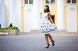 Young beautiful girl stands in front of house