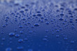 rain drops on a blue car body, shallow focus