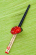 Sushi with chopsticks shot on green Sushi with chopsticks shot on green