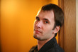 Portrait of handsome young adult man looking at camera