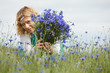 Women picking blue flowers Women picking blue flowers