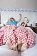 germany, bavaria, young couple lying in bed