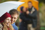Photo: germany, bavaria, english garden, four persons in beer garden, holding umbrella, smiling, portrait, close-up germany, bavaria, english garden, four persons in beer garden, holding umbrella, smiling, portrait, close-up