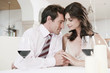 couple in restaurant holding hands, head to head, eyes closed, portrait