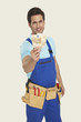 Foto: man wearing tool belt holding currency, smiling, portrait man wearing tool belt holding currency, smiling, portrait