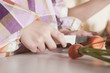 Photo: germany, cologne, children (6-7) slicing carrots, close-up germany, cologne, children (6-7) slicing carrots, close-up