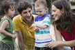 Photo: germany, berlin, parents looking at ladybird on childs (2-3) arm, laughing, portrait germany, berlin, parents looking at ladybird on childs (2-3) arm, laughing, portrait