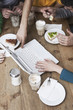 friends using laptop, having breakfast.