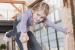 germany, cologne, person playing with girl (4-5) in garden, portrait