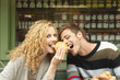 germany, bavaria, munich, young couple at viktualienmarkt having snack, portrait