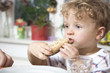 germany, berlin, boy (3-4) holding bread roll, portrait, close-up