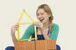 woman holding tape measure, winking