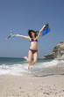 asia, thailand, young woman jumping on beach