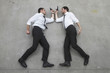 two businessmen duelling with weapons, portrait, elevated view
