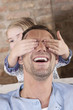 germany, cologne,girl (6-7) covering father's eyes, portrait, close-up