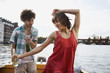 Foto: germany, berlin, young couple on motorboat, man looking at woman dancing, portrait germany, berlin, young couple on motorboat, man looking at woman dancing, portrait