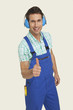 man wearing ear muff showing thumbs up sign, smiling, portrait
